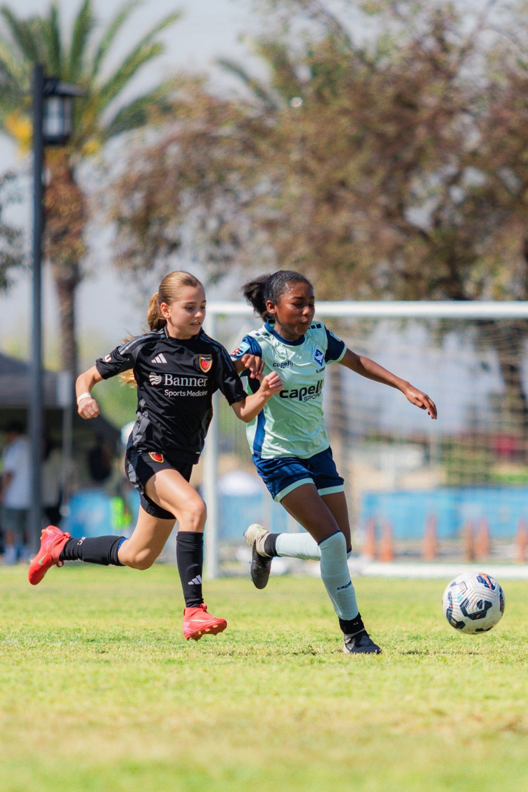 London in a duel for the ball in the ECNL playoffs
