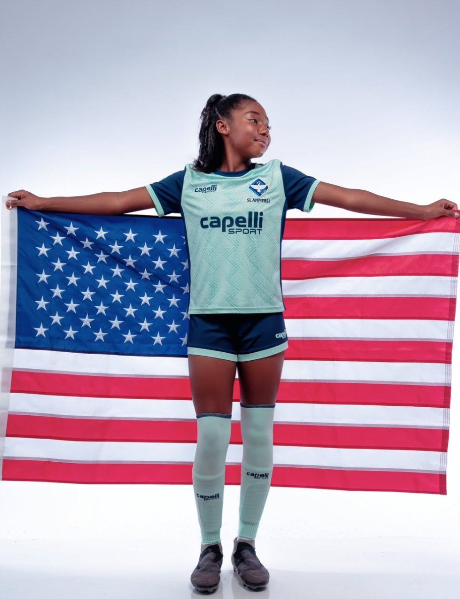 London holding an American flag behind her