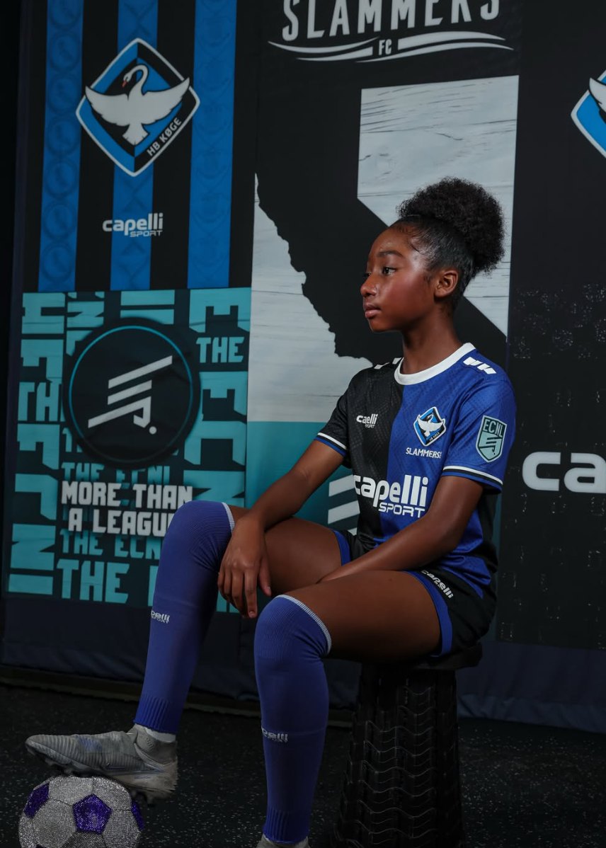 London seated with a ball at her feet