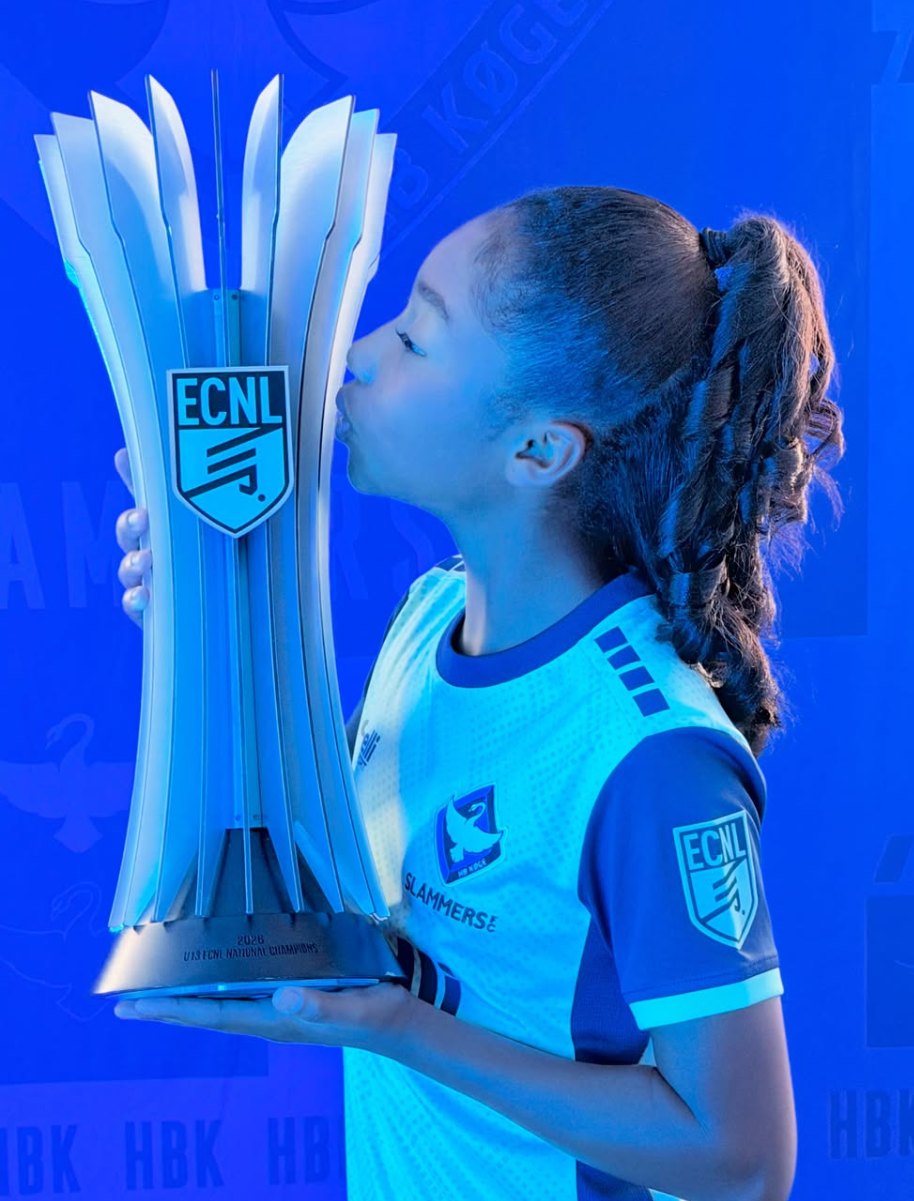 London kissing the ECNL national championship trophy