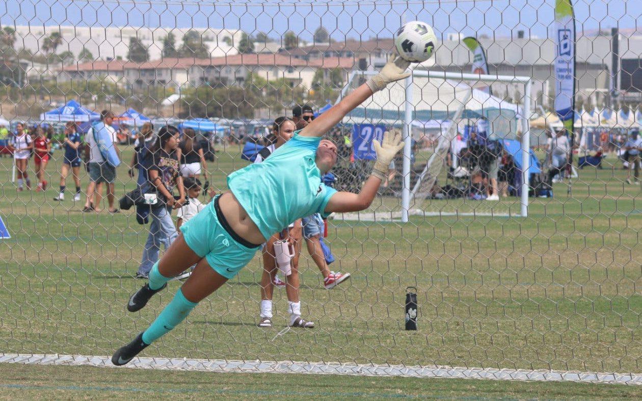 Naiomi Tase at full stretch for a save